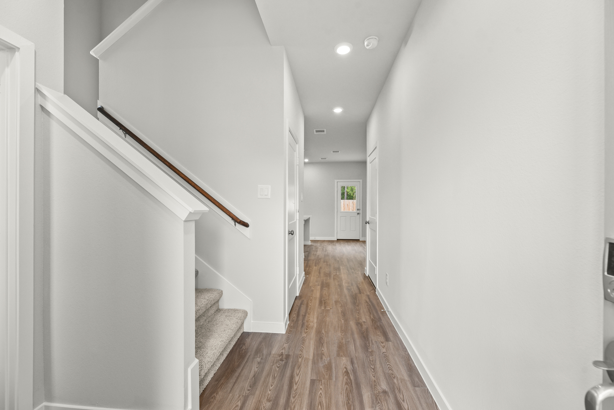 A hallway with white walls.