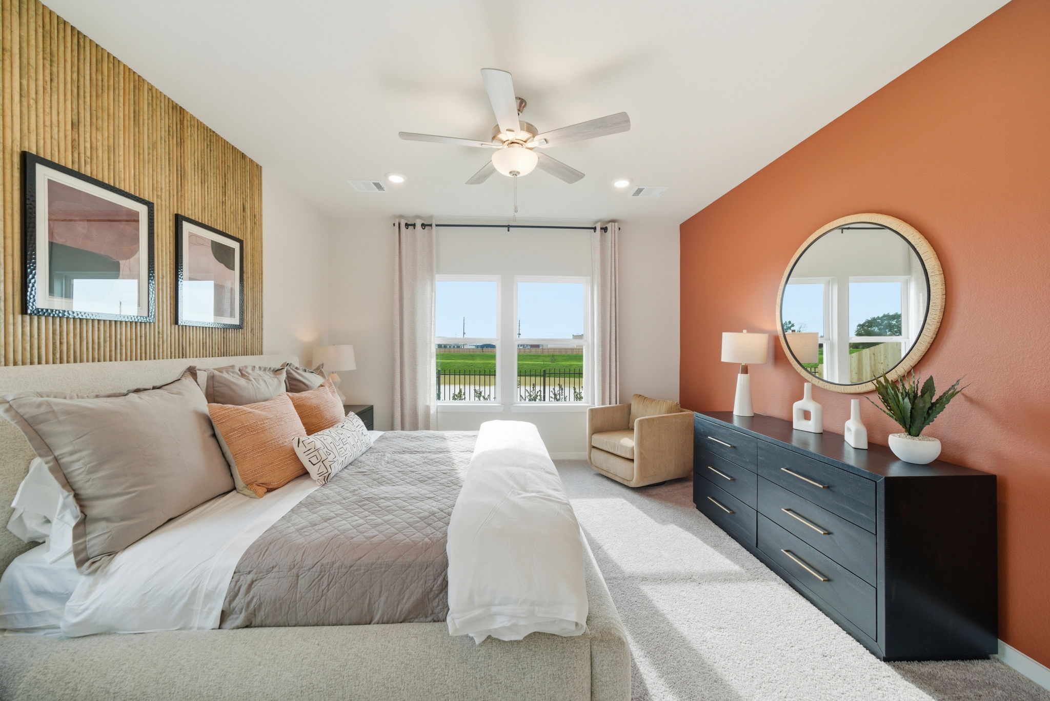 A bedroom with a large mirror.