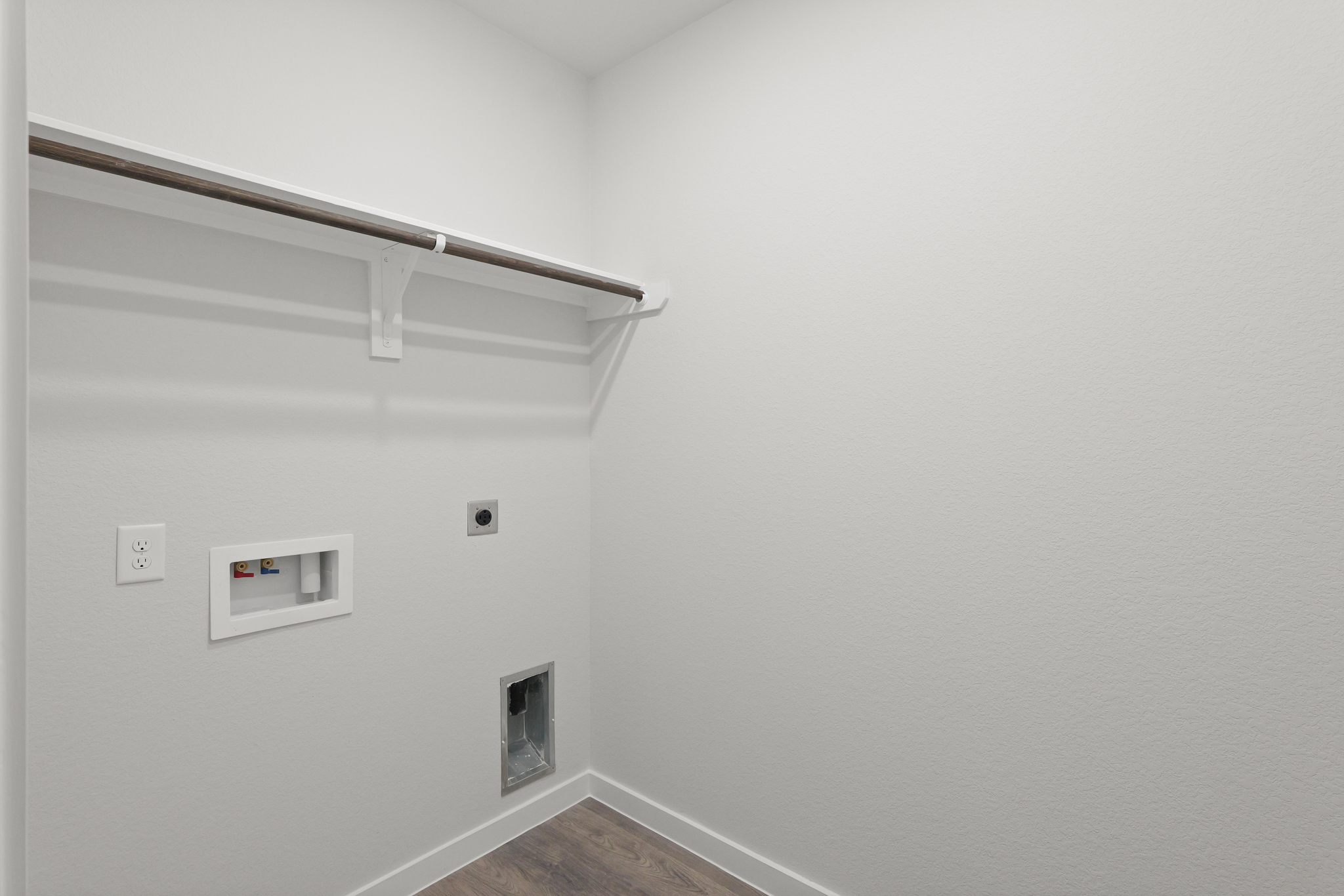 A white wall with a light fixture.