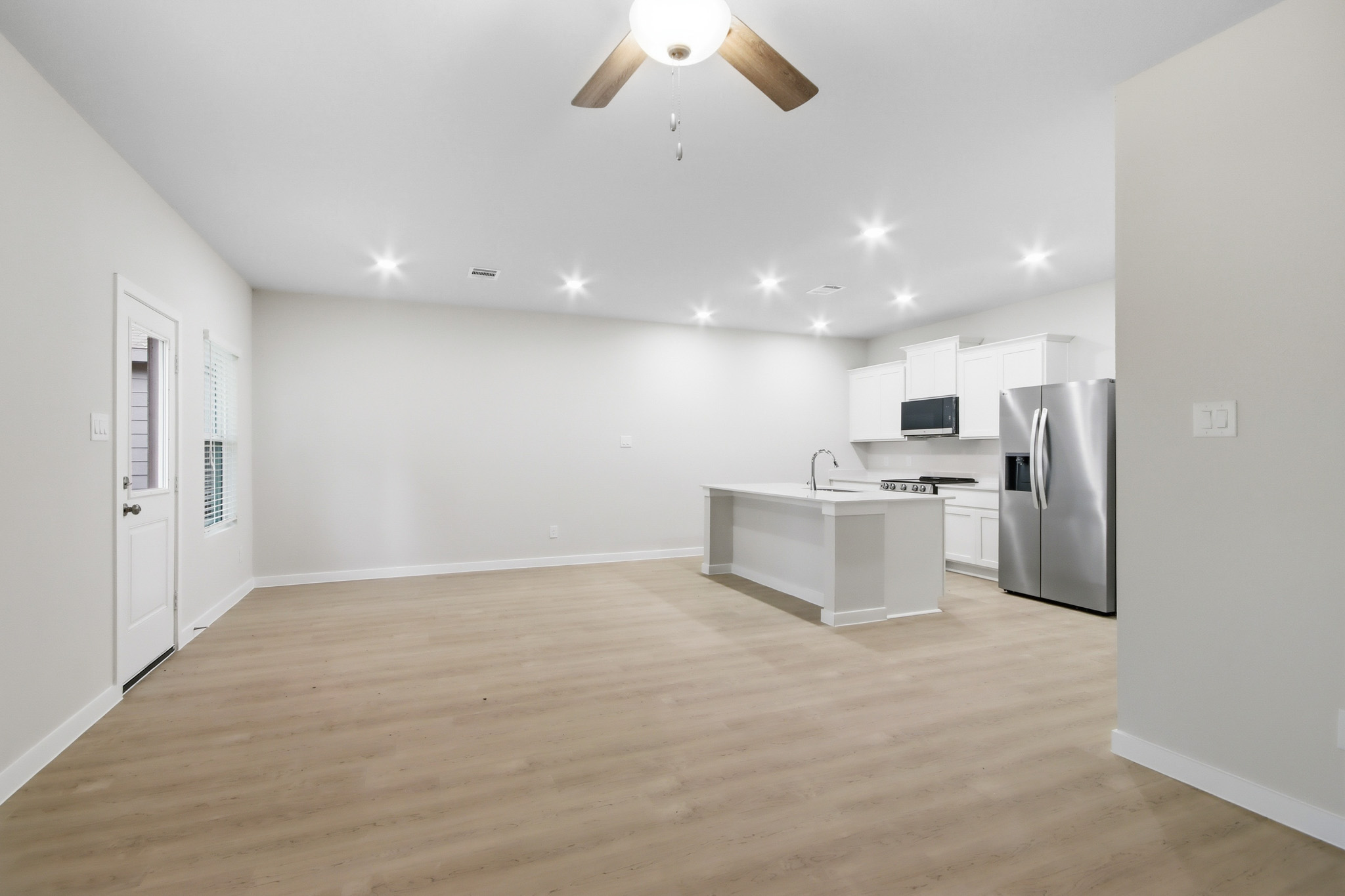 A kitchen with white cabinets.