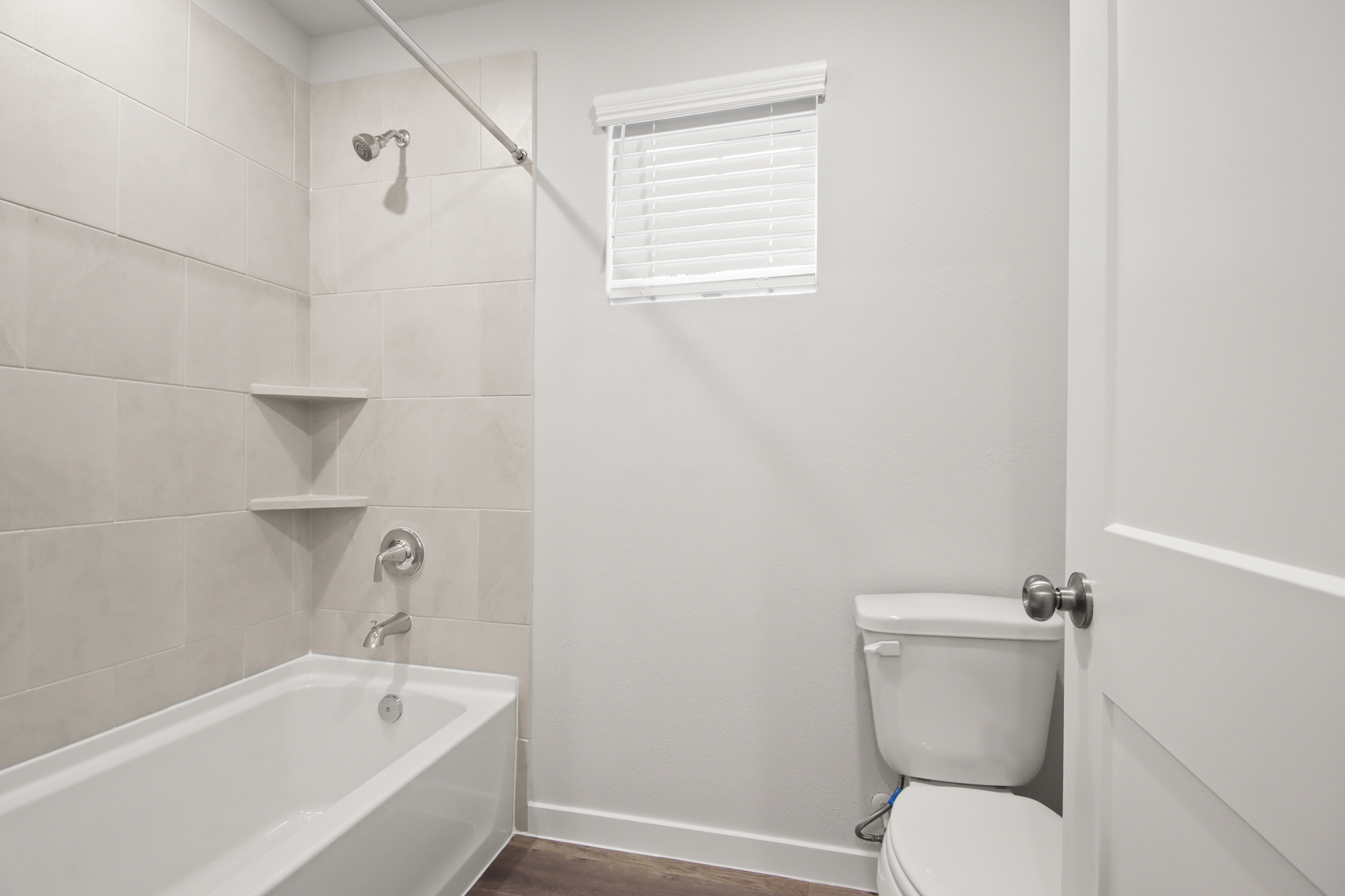 A bathroom with a tub toilet and sink.