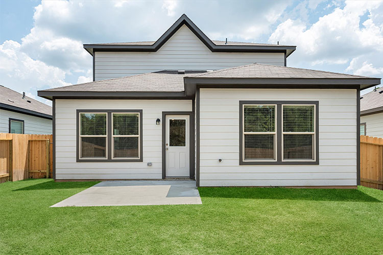 A house with a fence and grass.