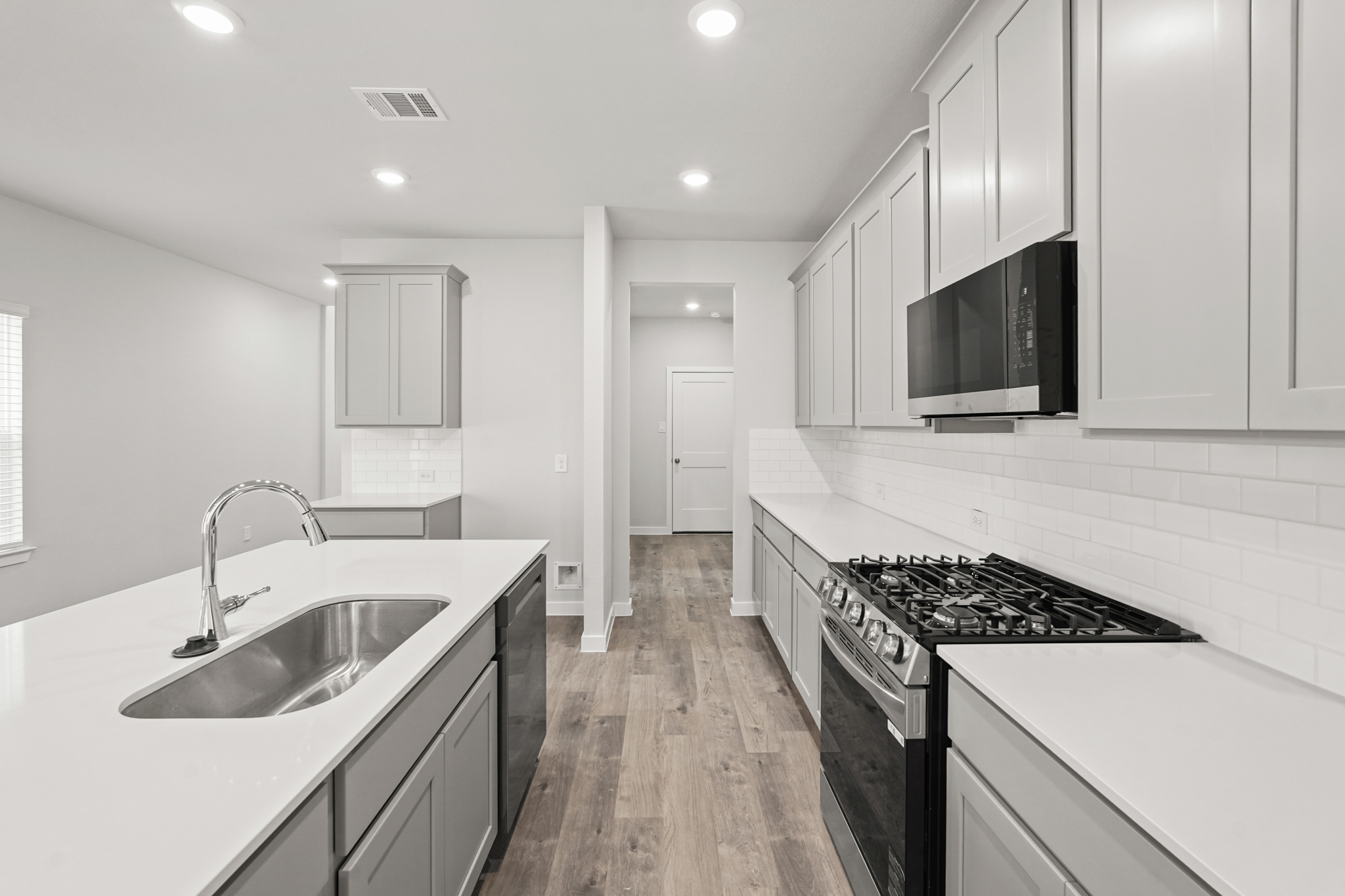 A kitchen with white cabinets.