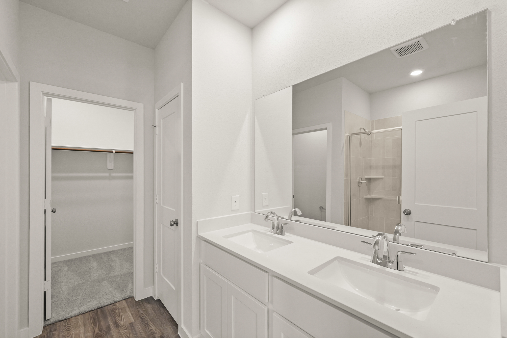 A bathroom with a large mirror.