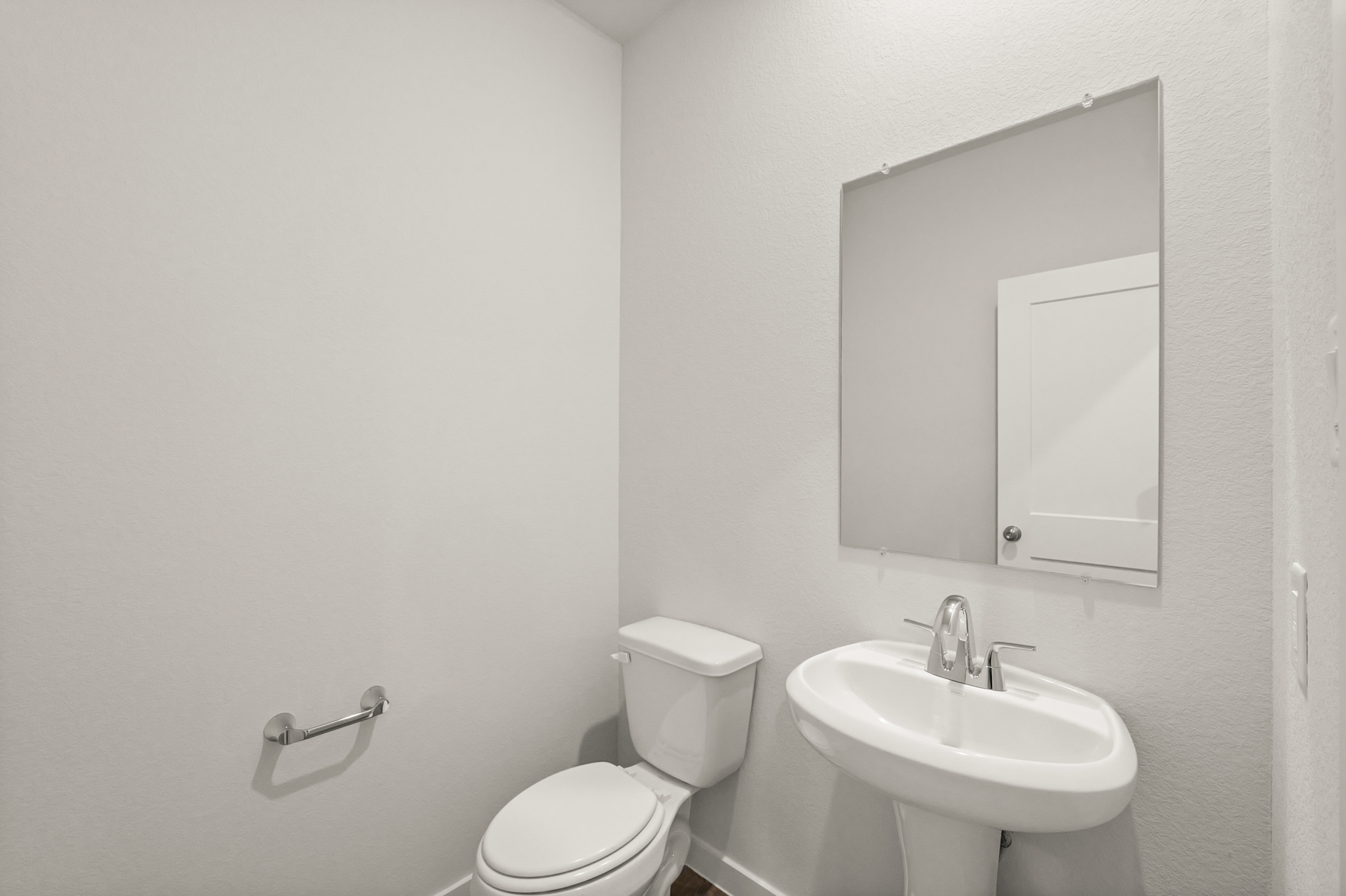 A bathroom with a toilet and sink.