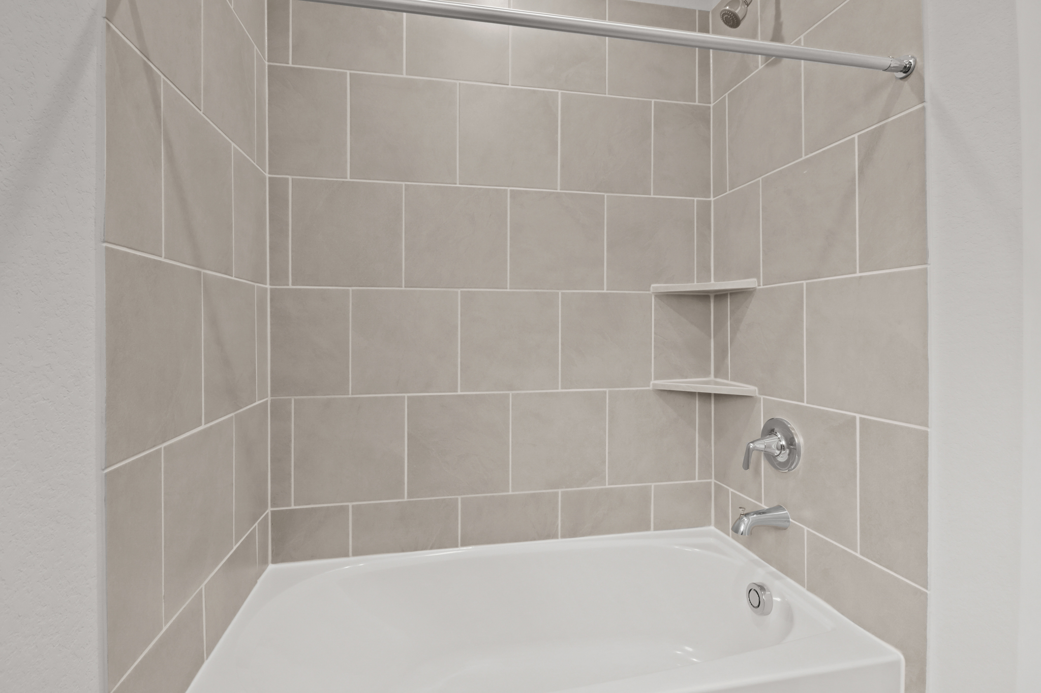 A bathtub in a bathroom.