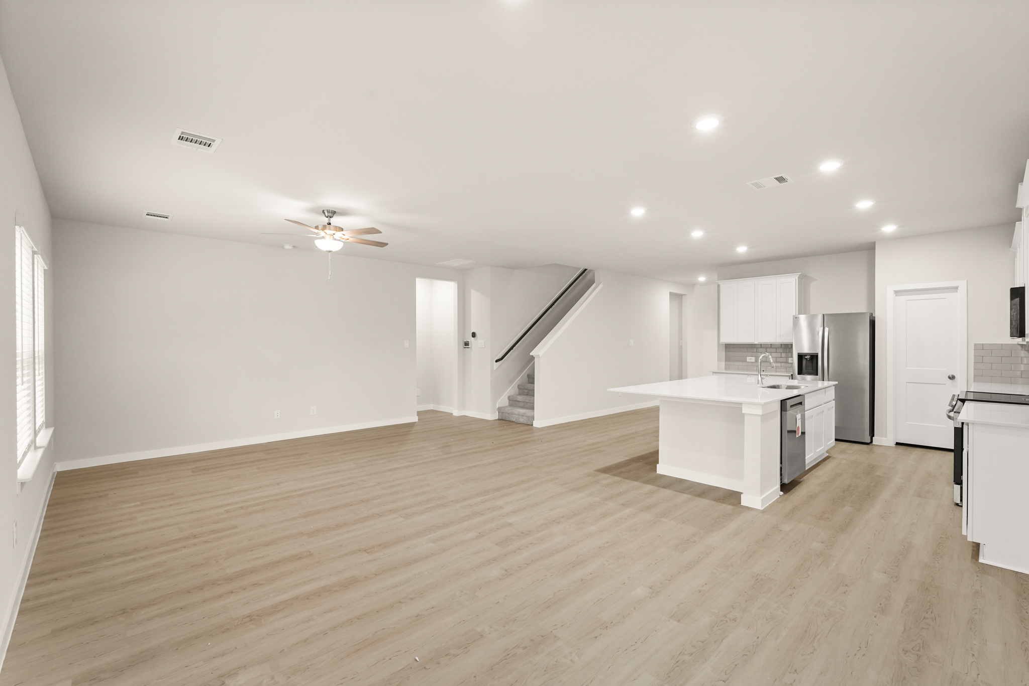 A large kitchen with white cabinets.