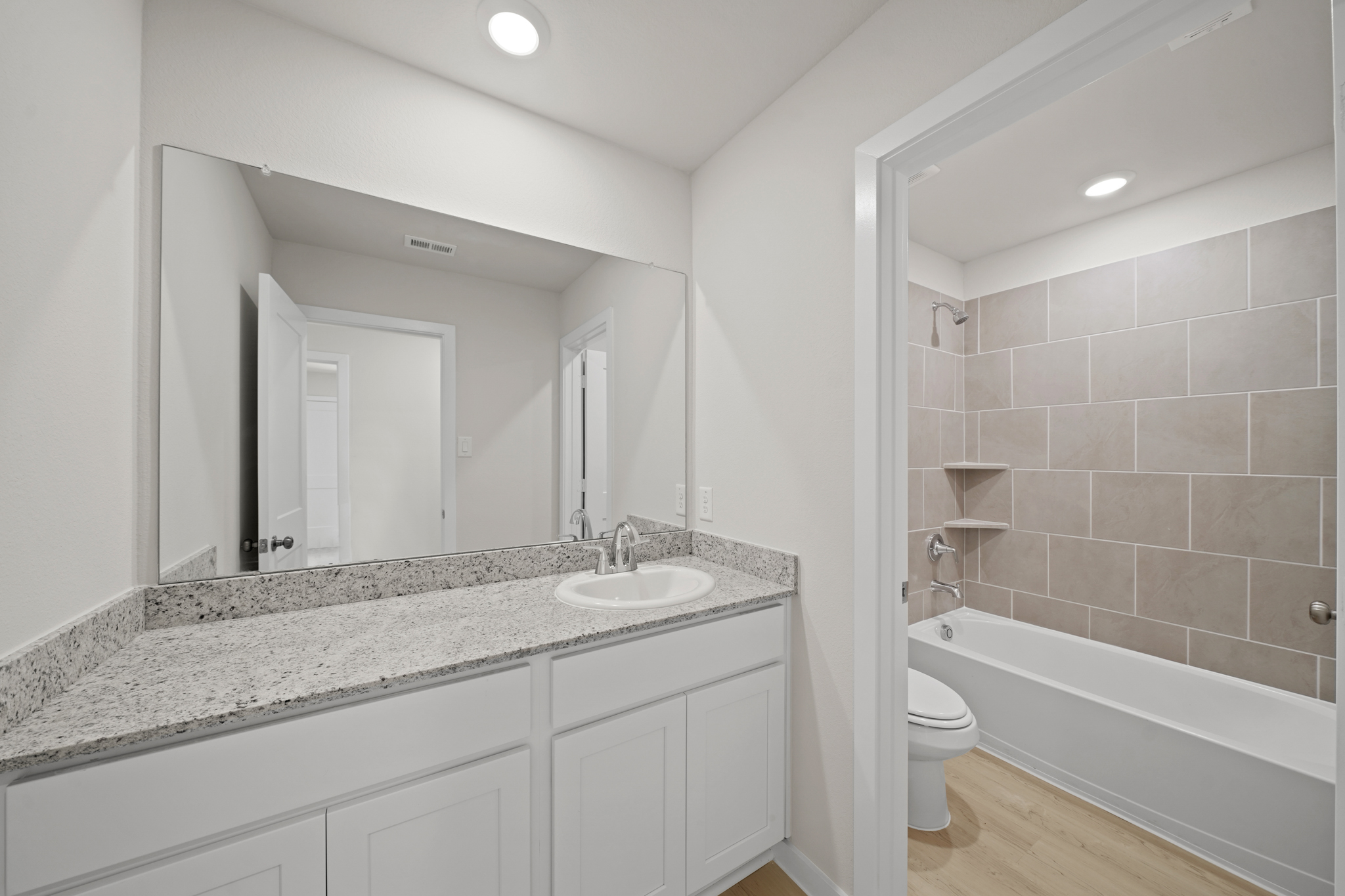 A bathroom with a marble countertop.