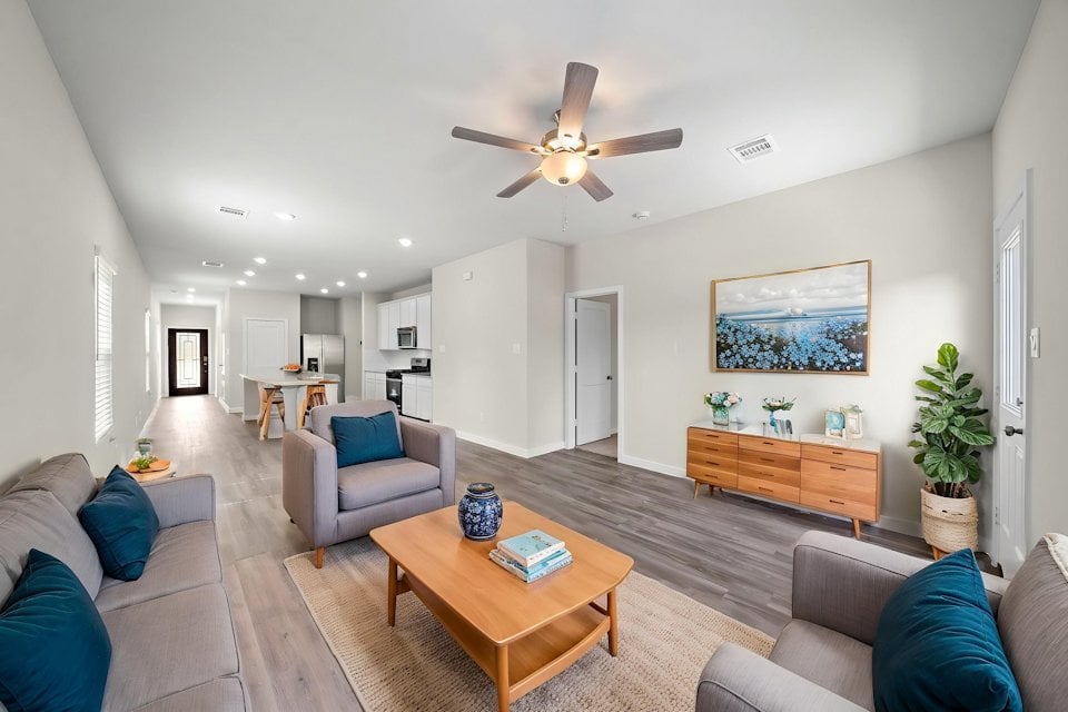A living room with a ceiling fan.
