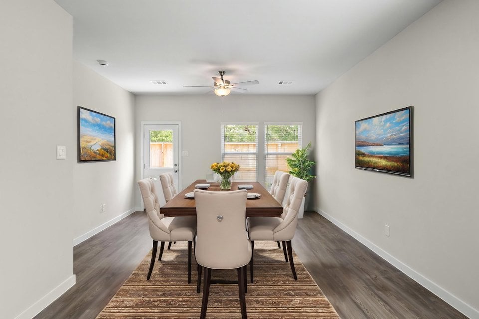 A dining room table with chairs.