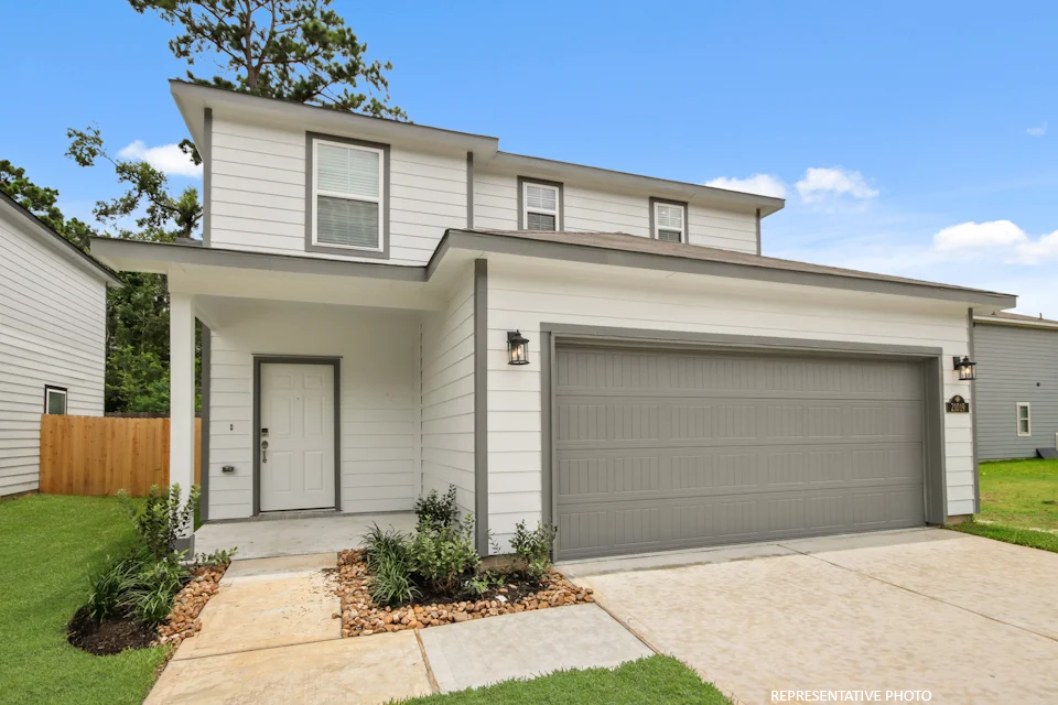 A house with garages and a driveway.