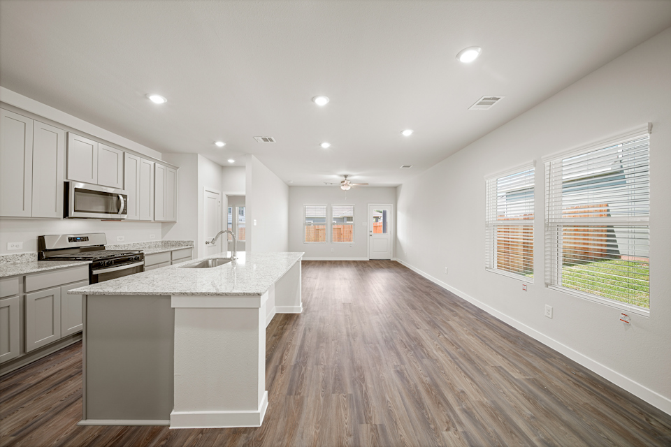 A kitchen with white cabinets.