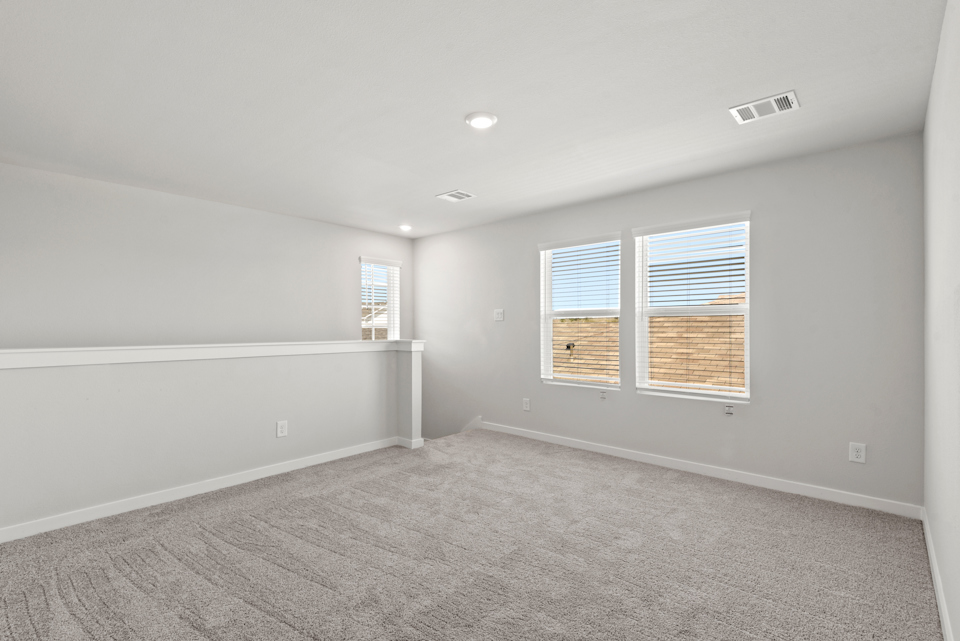 A room with a window and a carpet.