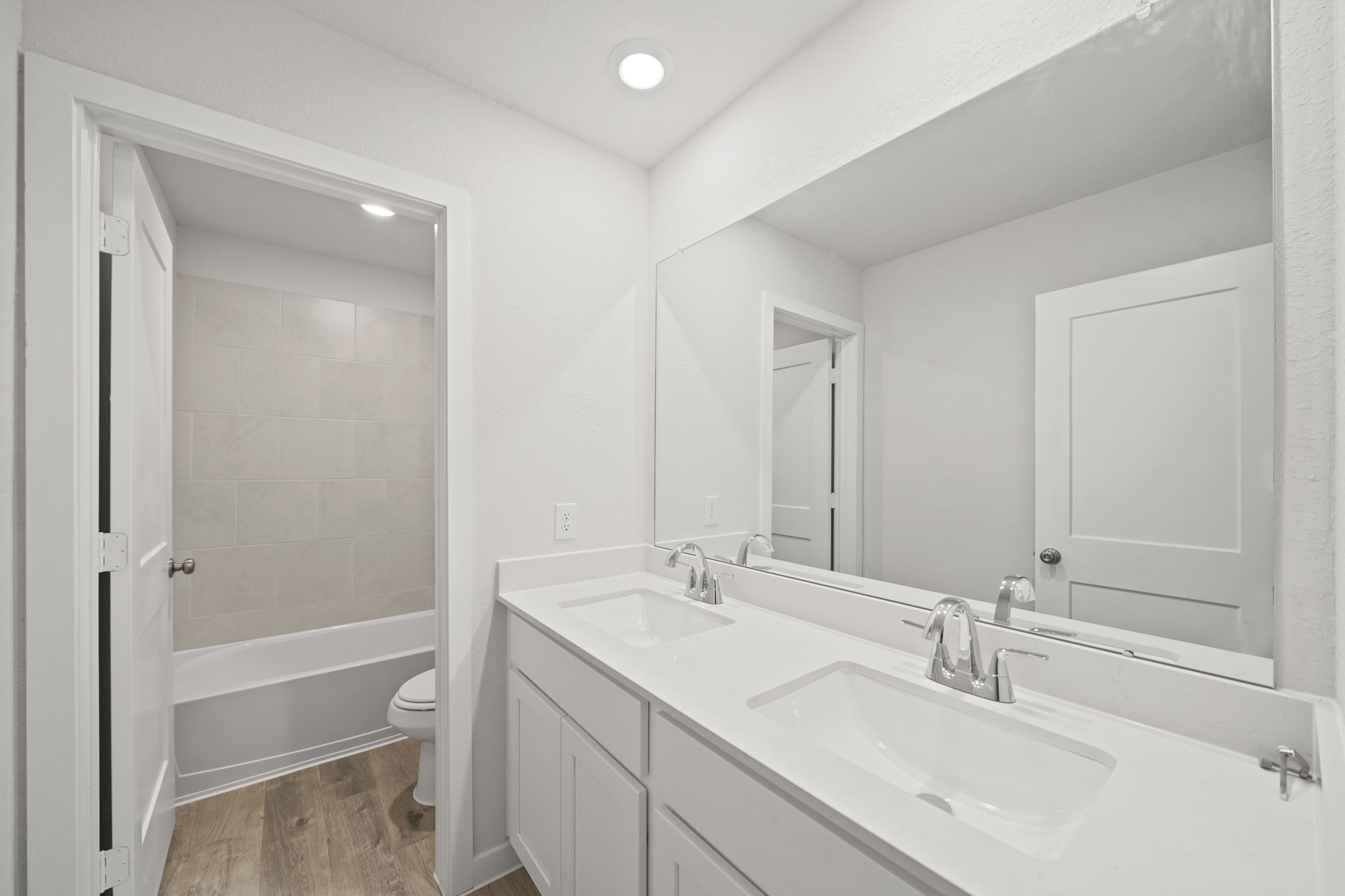 A bathroom with a sink and a shower.