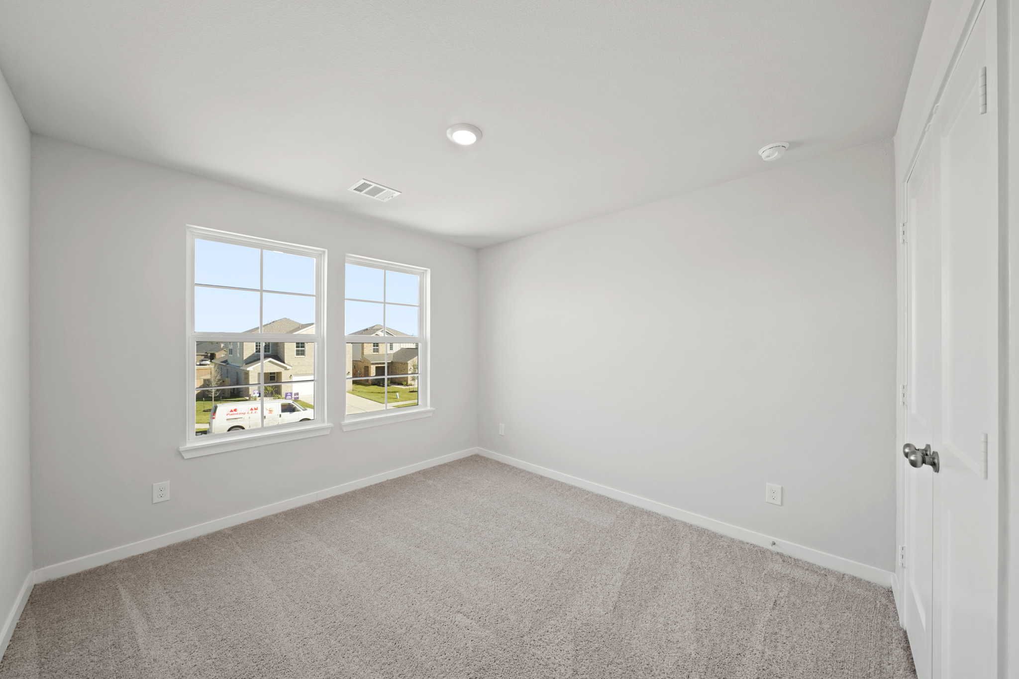 A room with a carpet and a window.
