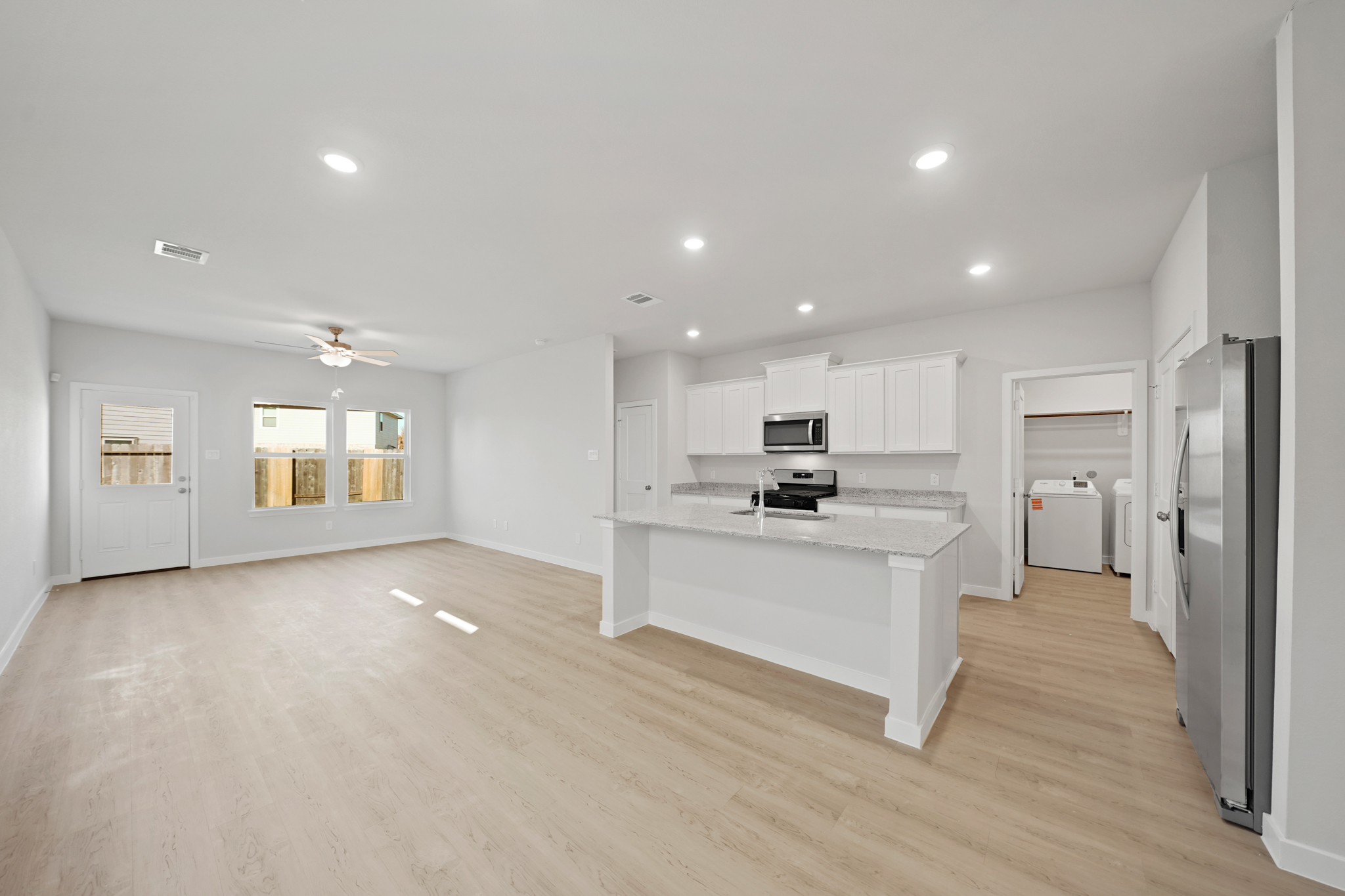 A large kitchen with white cabinets.