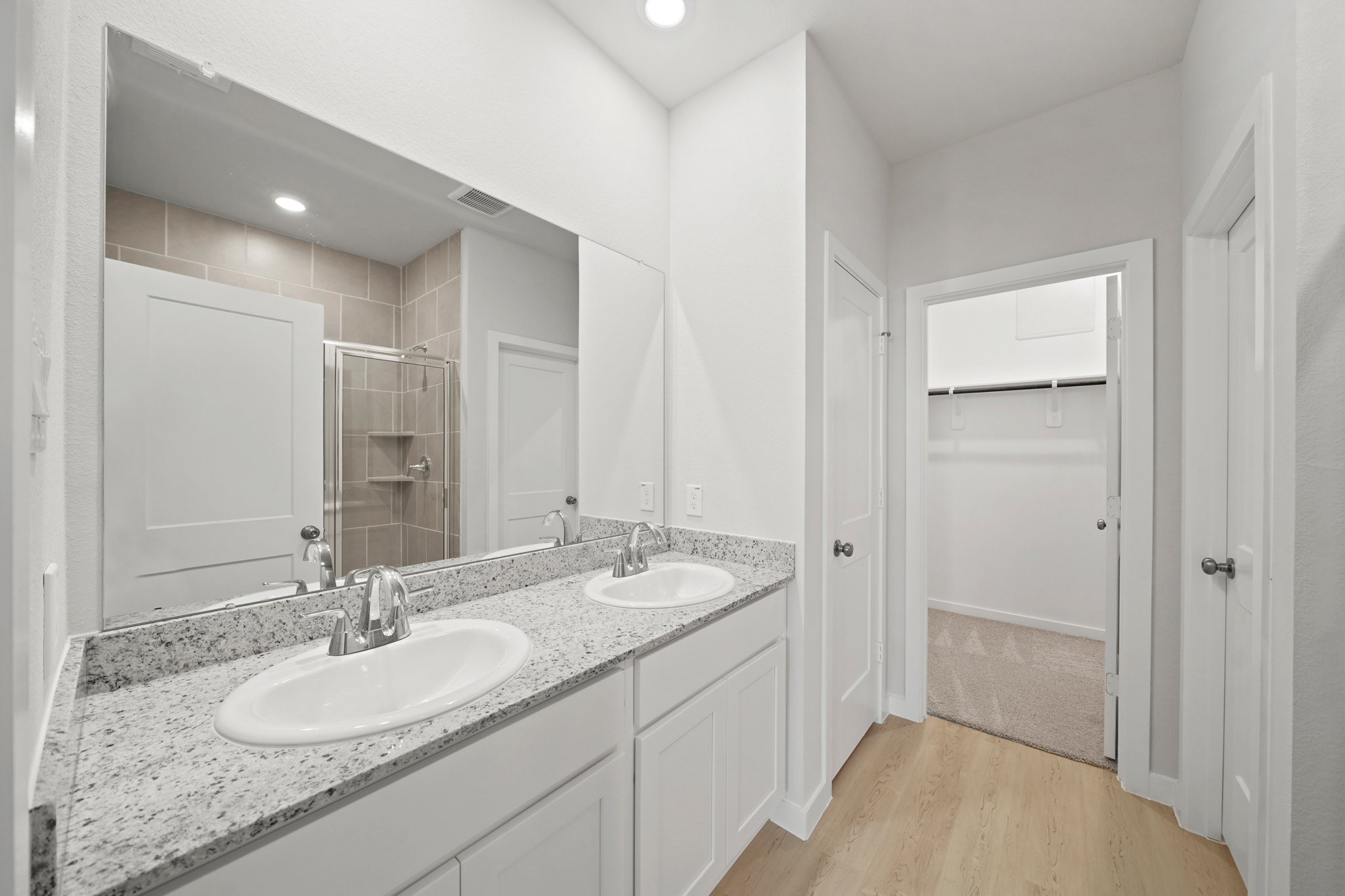 A bathroom with a large mirror.