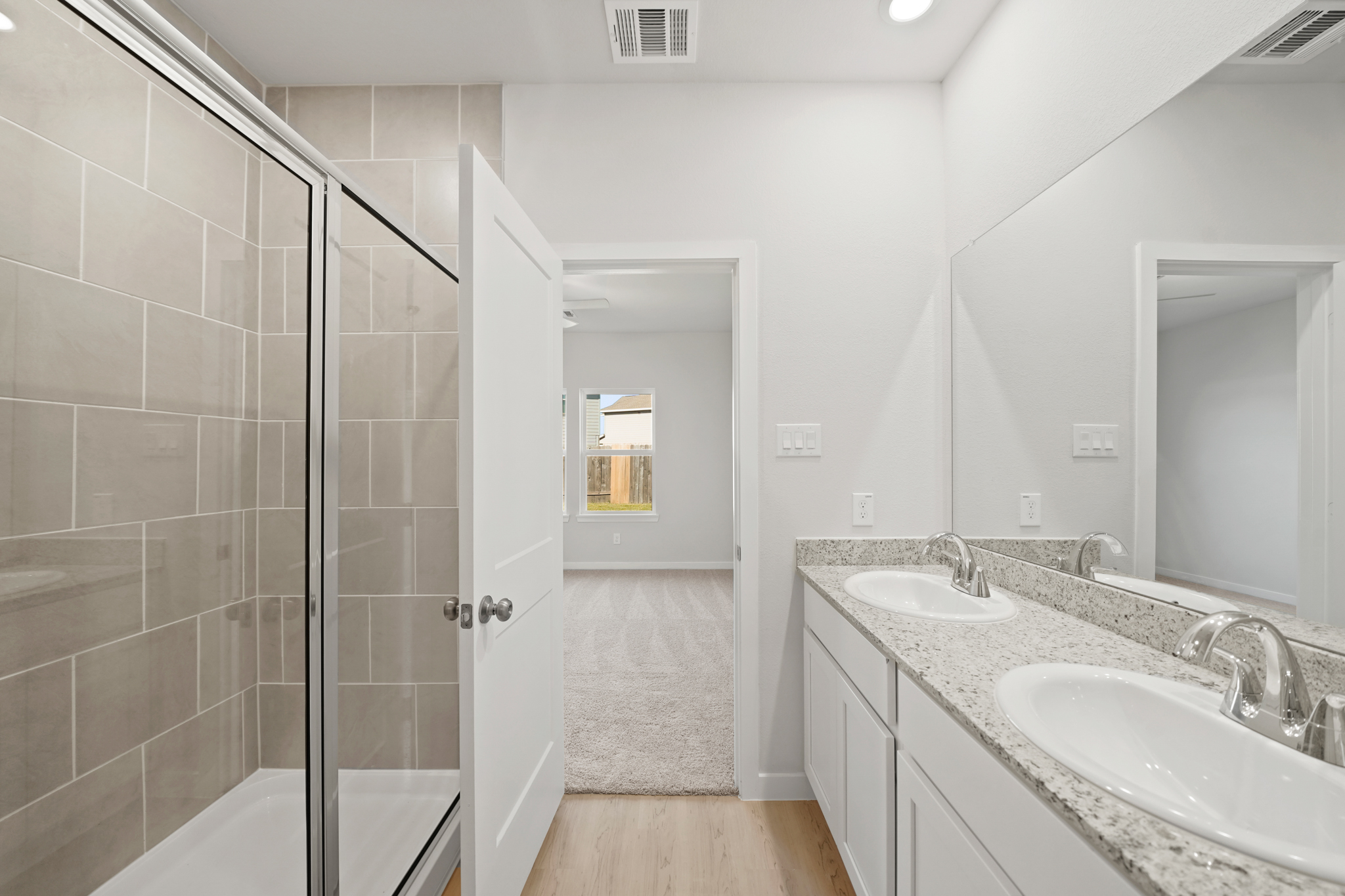 A bathroom with a sink and a shower.