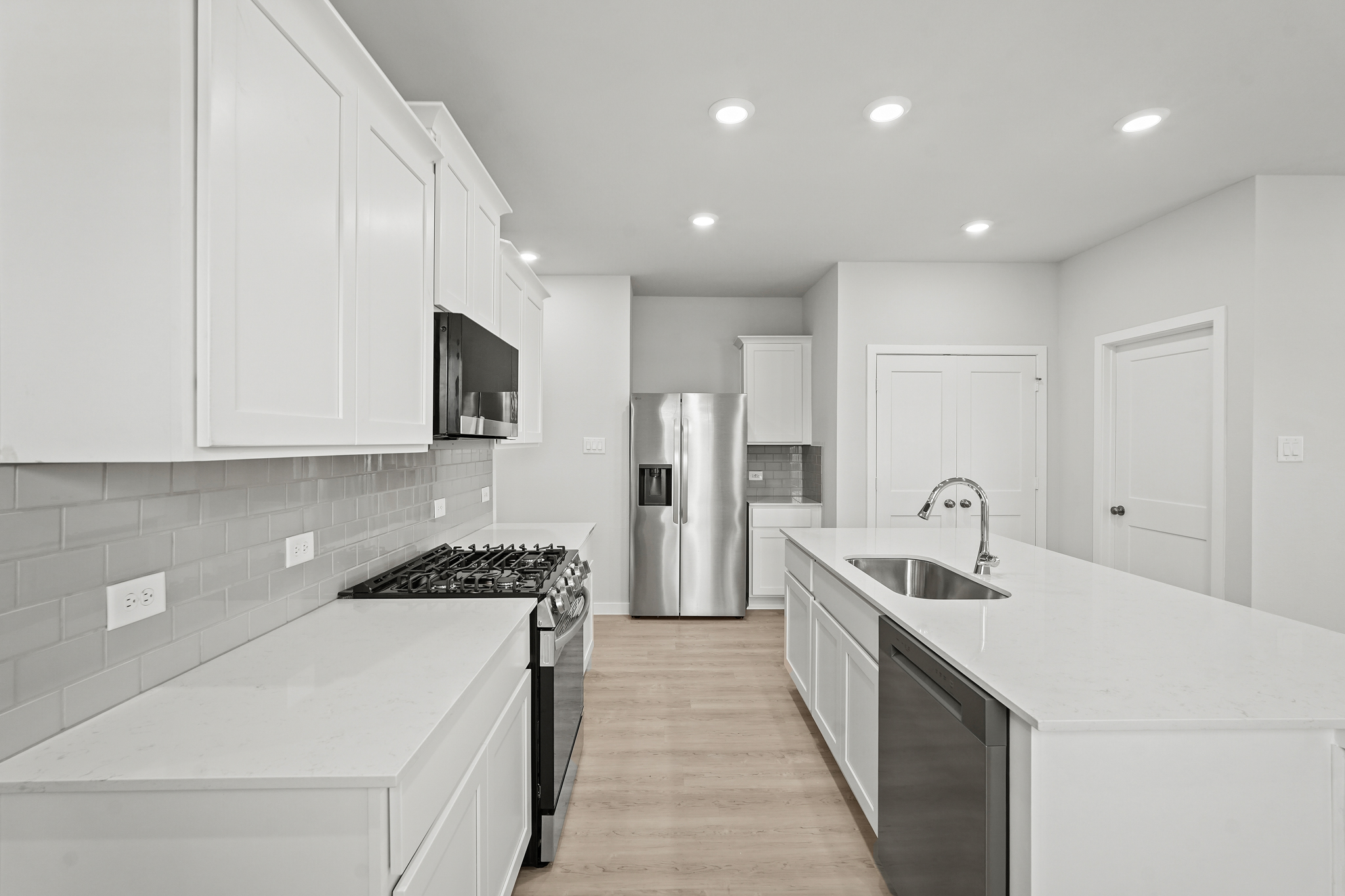 A kitchen with white cabinets.