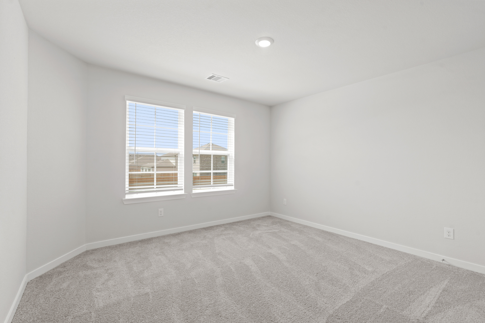 A room with a window and a carpet.