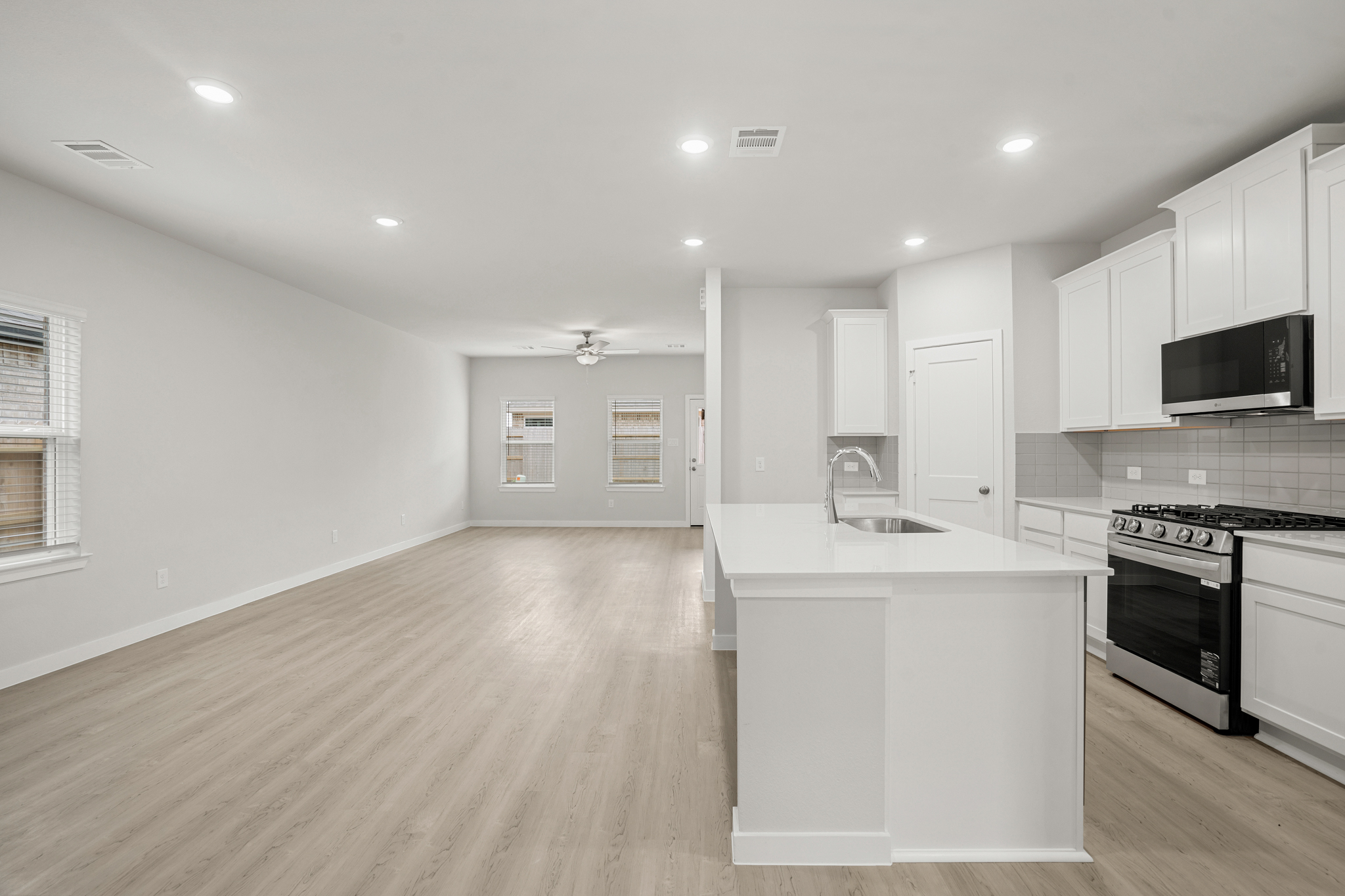 A kitchen with white cabinets.