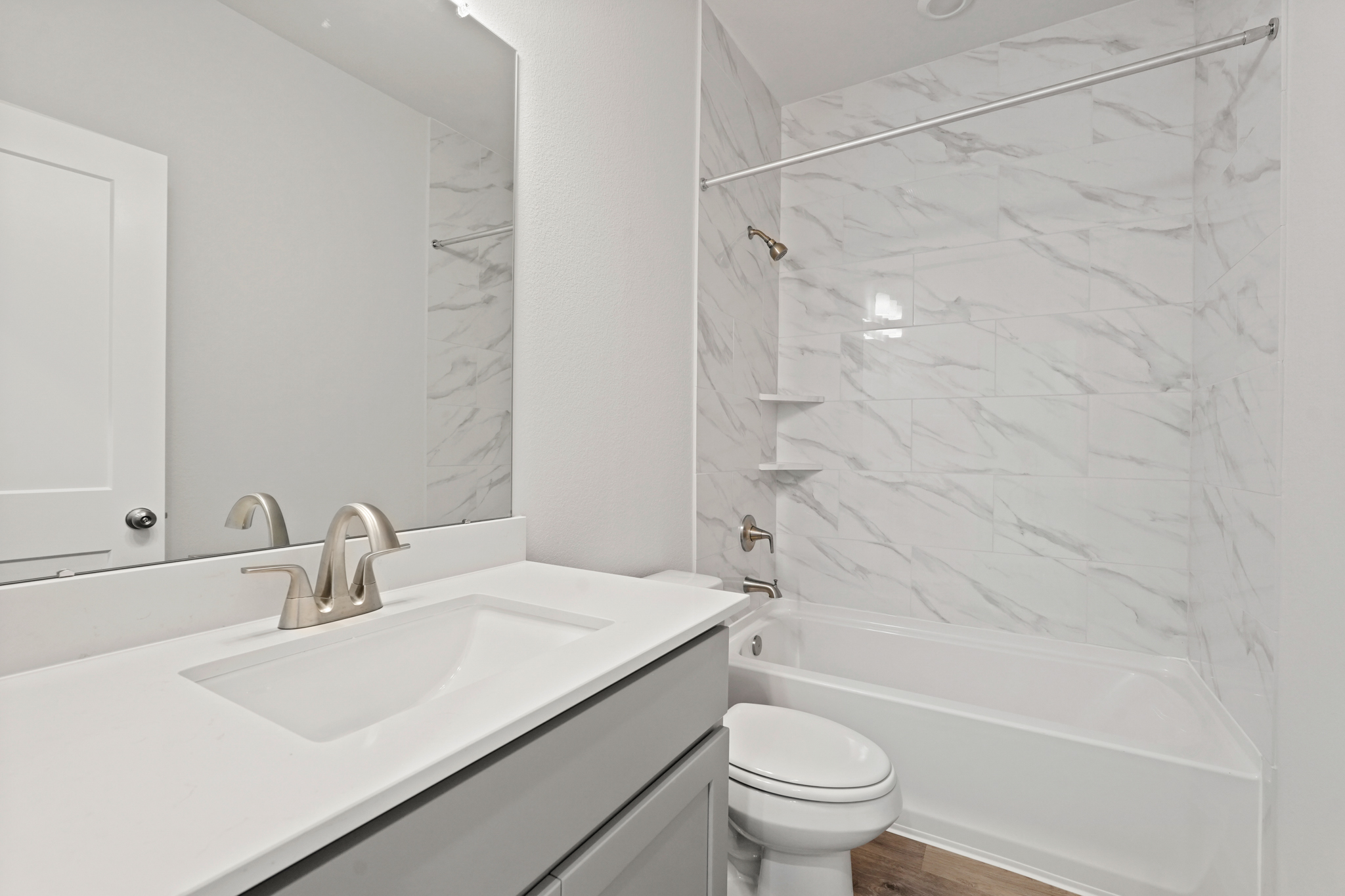 A bathroom with a sink and a toilet.