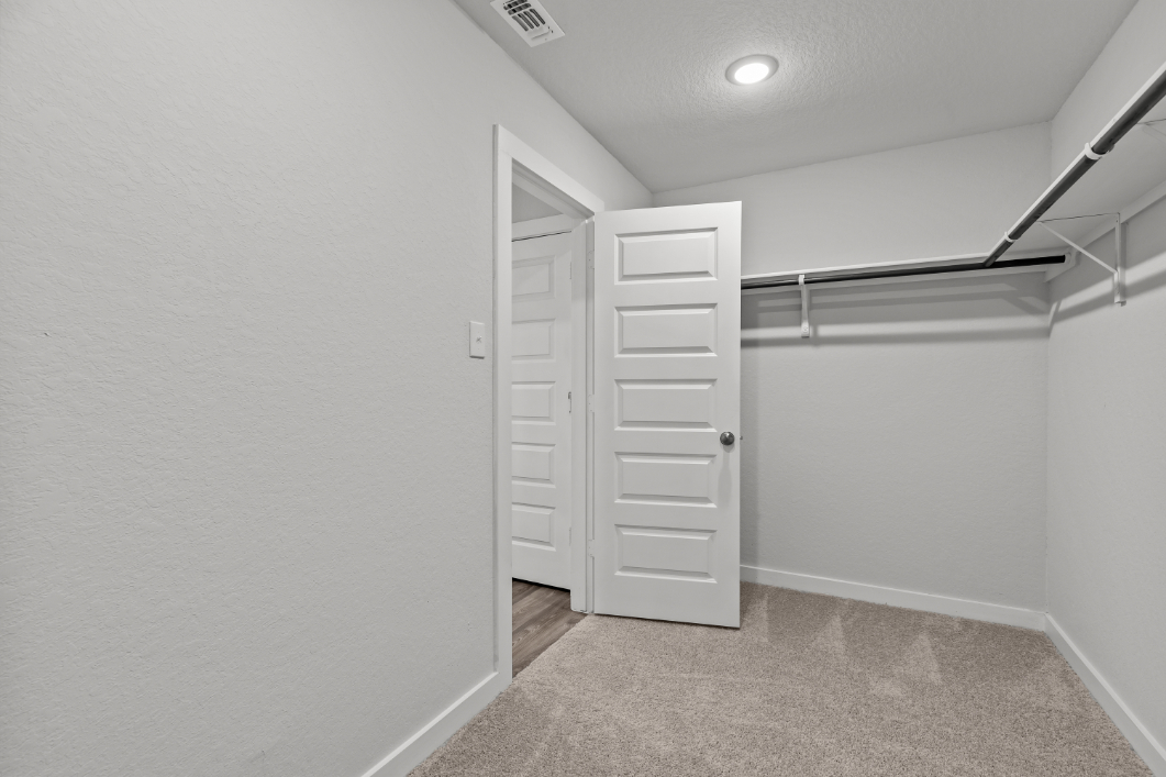 A hallway with white doors.
