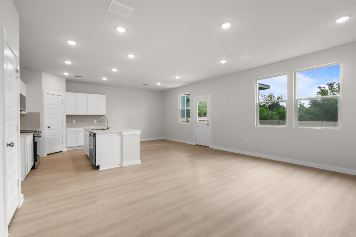 A kitchen with white cabinets.