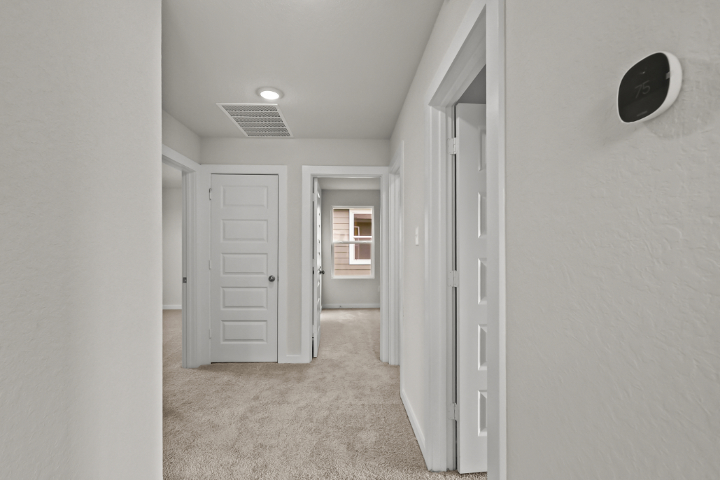 A hallway with white doors.