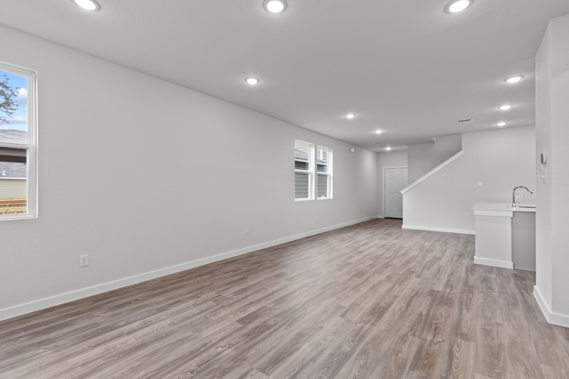 A room with a wood floor and a sink.