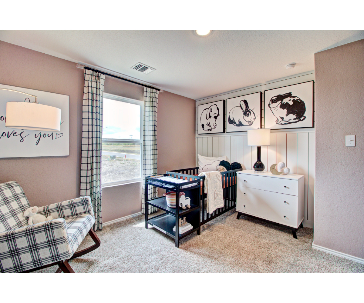 A bedroom with a bed and a chair.