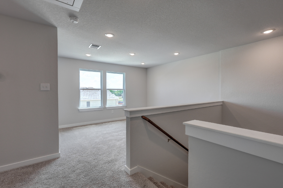 A room with a window and a staircase.