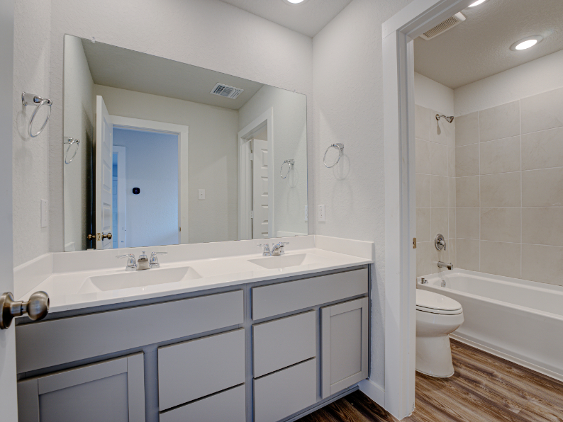 A bathroom with a tub sink and toilet.