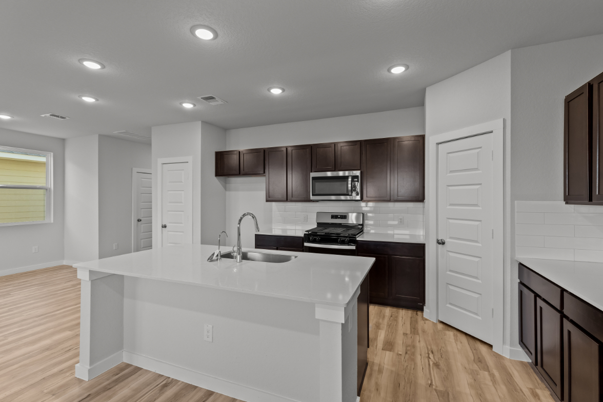 A kitchen with black cabinets.
