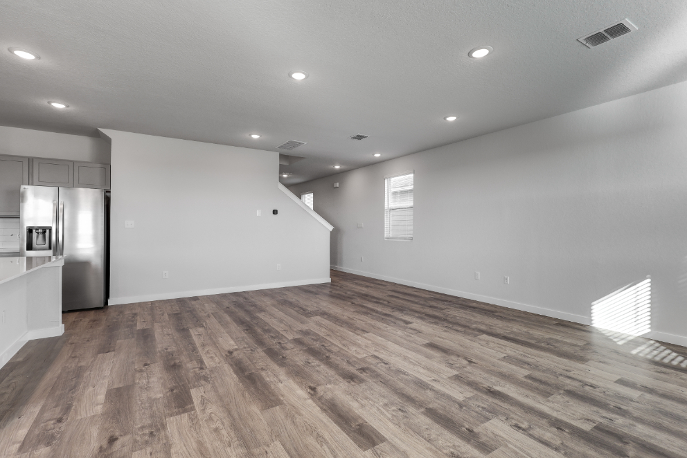 A room with a wood floor and white walls.