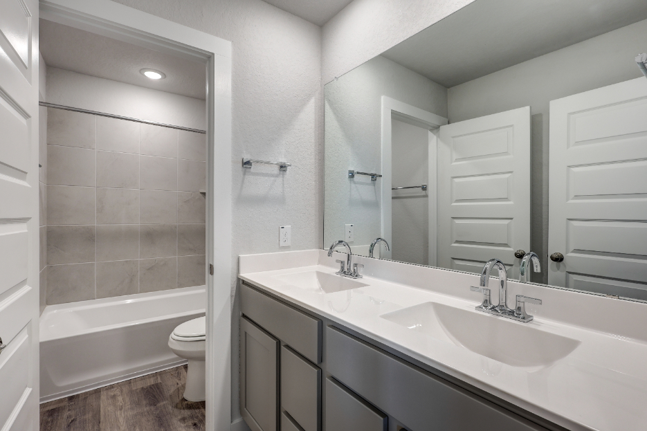 A bathroom with a tub sink and toilet.