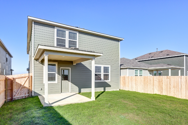 A house with a fence and grass.
