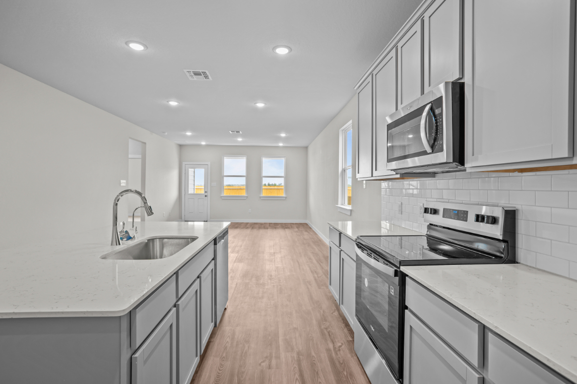 A kitchen with white cabinets.
