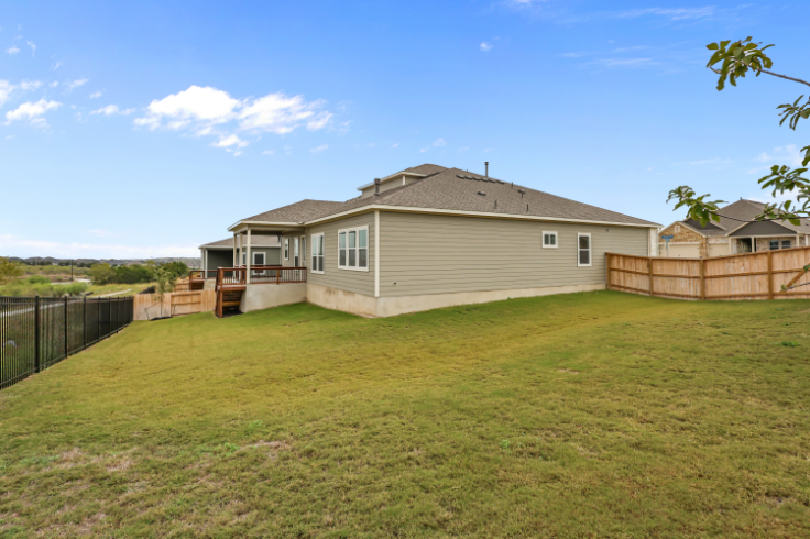 A house with a fence and grass.