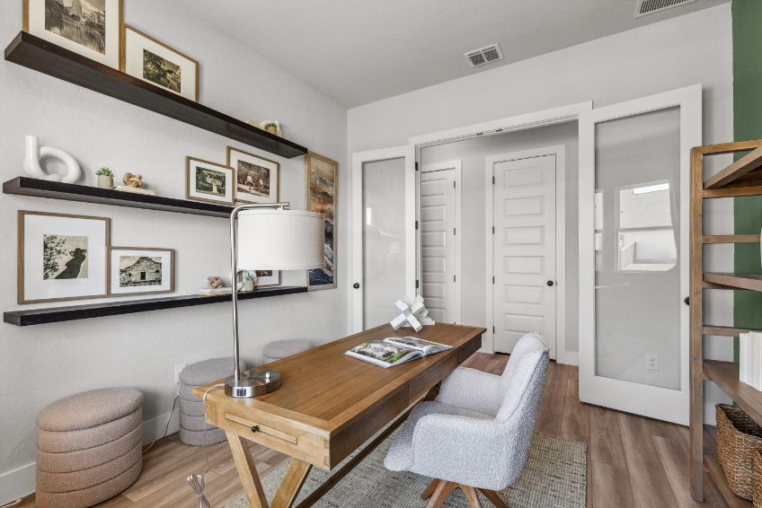 A living room with a table and chairs.