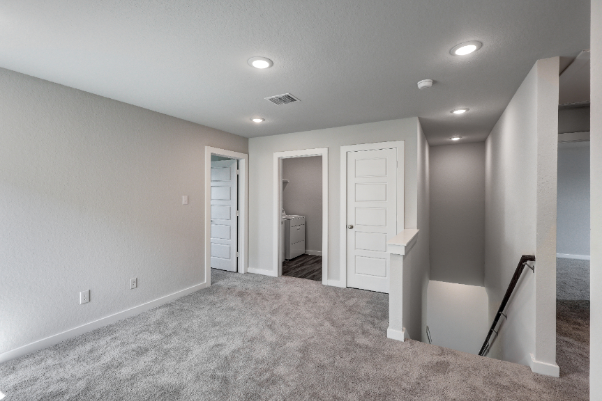 A hallway with white doors.