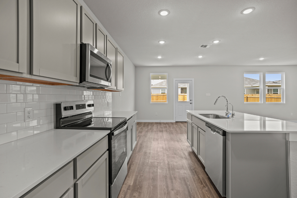 A kitchen with white cabinets.