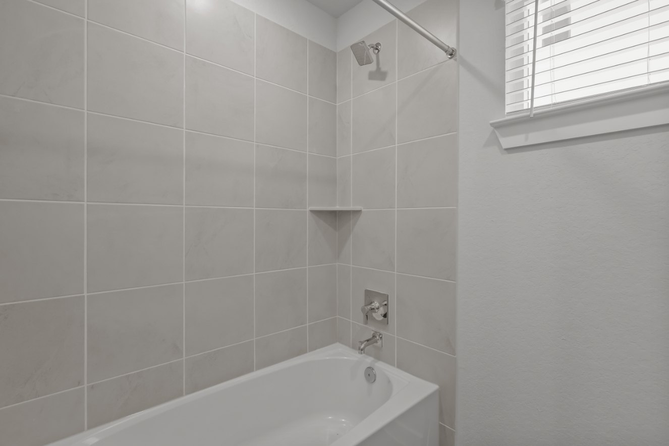 A bathtub in a bathroom.