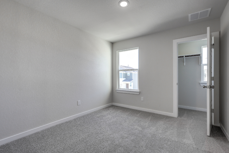 A room with a window and a door.