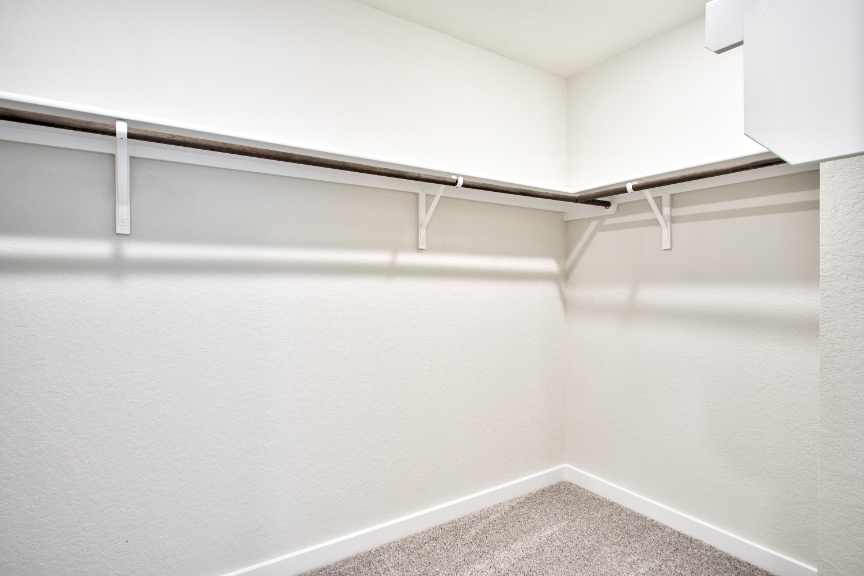 A white wall with a metal railing.