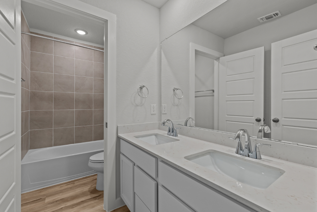 A bathroom with a tub sink and toilet.