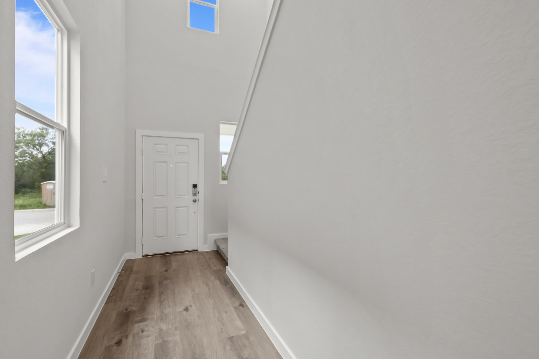 A room with a door and windows.