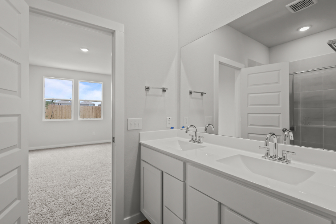 A bathroom with a large mirror.
