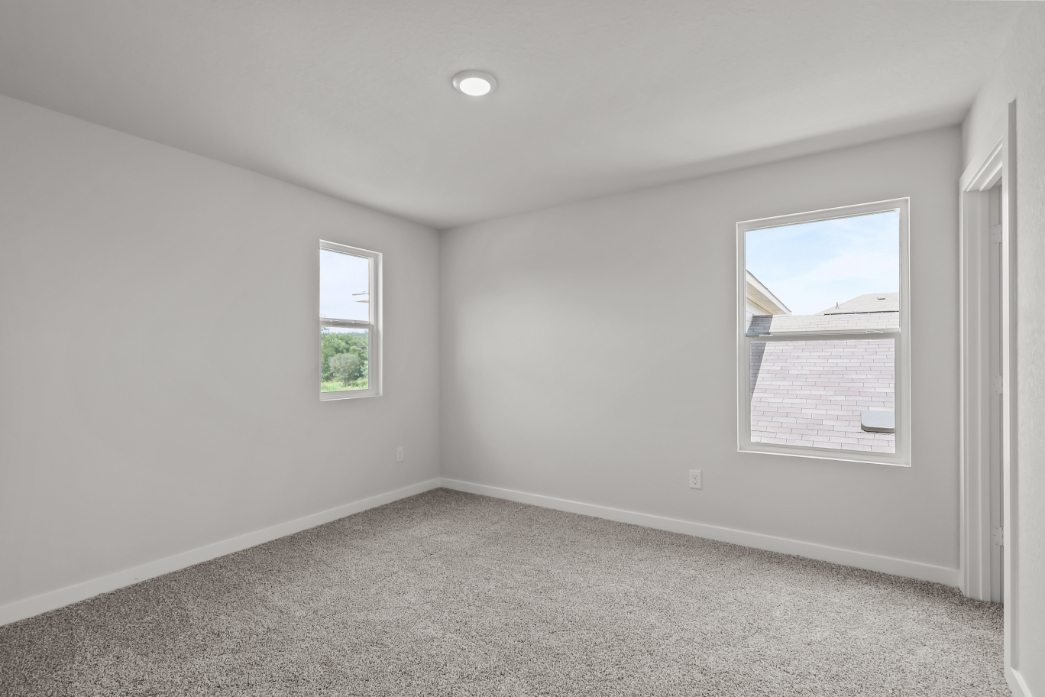 A room with a window and a carpet.