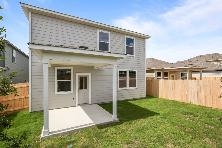 A house with a fence and grass.